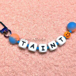 T@INT: Silicone Offensive Keychain: Glow Orange & Light Blue Split